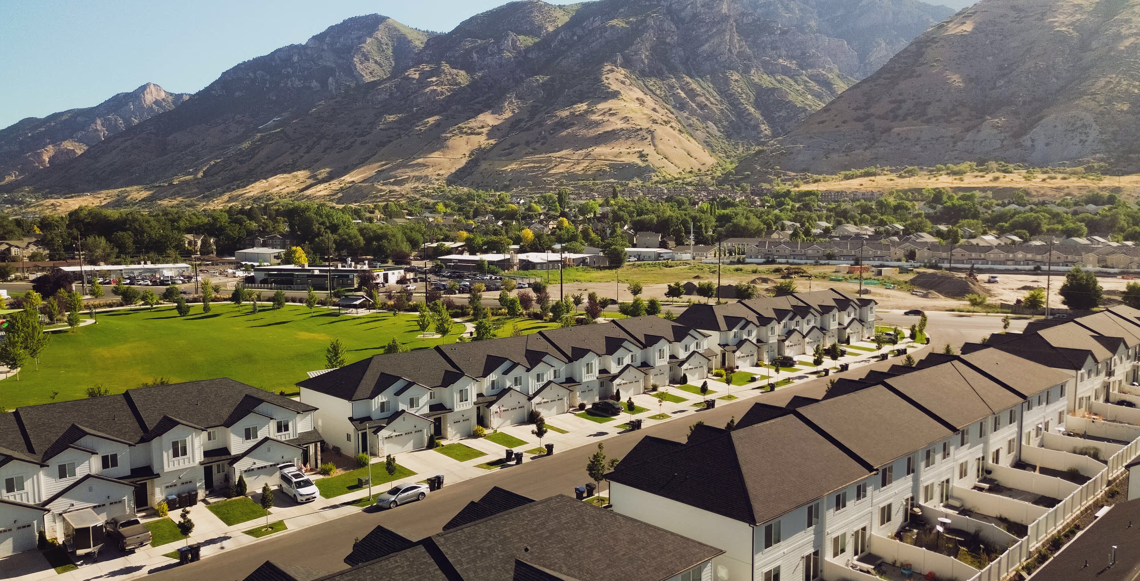 Aerial view of a Utah multifamily community with townhomes set against the mountains.